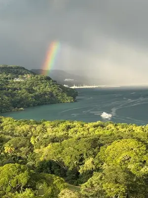 a rainbow over a lake with trees and forests at El Sueño in Nacascolo