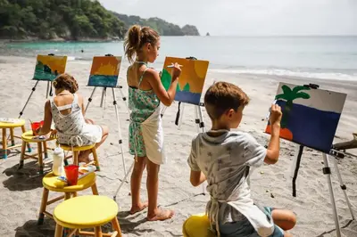 a group of children painting on the beach at El Sueño in Nacascolo