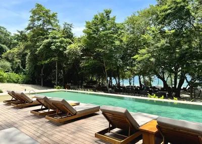 a group of lounge chairs and a swimming pool at Monkey Villa in Nacascolo