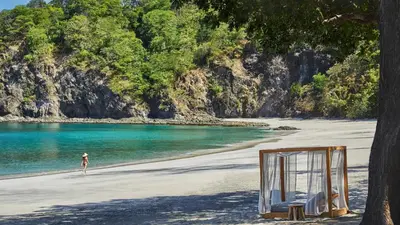 a person standing on a beach with a mirror at Monkey Villa in Nacascolo