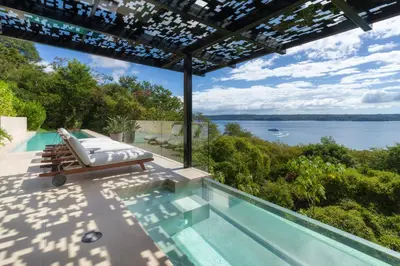 a swimming pool with a view of the water at Villa Coral in Nacascolo