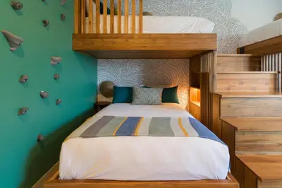 a childs bedroom with a bunk bed and stairs at Villa Tortuga in Nacascolo