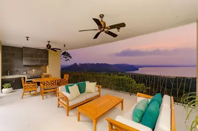 a patio with furniture and a view of the water at Villa Tortuga in Nacascolo