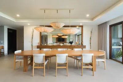 a dining room with a wooden table and chairs at Villa Tortuga in Nacascolo