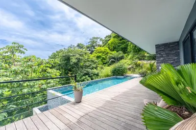 a house with a swimming pool on a wooden deck at Villa with Stunning Isla Tortuga Ocean View, Near Curu Park & Ferry in Blue Zone in Paquera