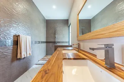 a bathroom with a tub and a sink and a mirror at Villa with Stunning Isla Tortuga Ocean View, Near Curu Park & Ferry in Blue Zone in Paquera