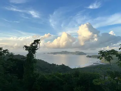 a view of a body of water with trees and clouds at Villa with Stunning Isla Tortuga Ocean View, Near Curu Park & Ferry in Blue Zone in Paquera