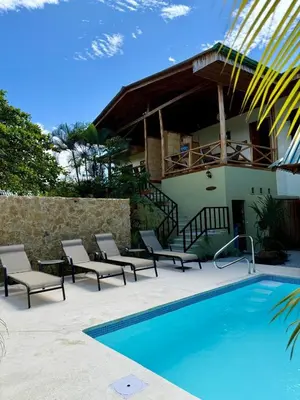 a house with a swimming pool next to a house at Villas Solar in Santa Teresa Beach