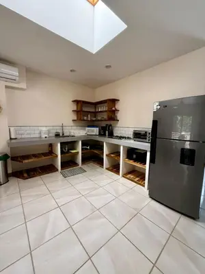 a kitchen with a stainless steel refrigerator at Villas Solar in Santa Teresa Beach