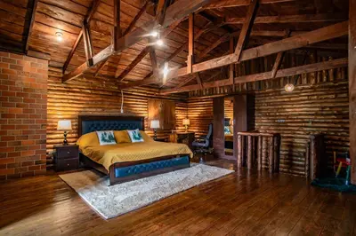 a bedroom with a bed and a brick wall at Cabaña English Evergreen in Jardín