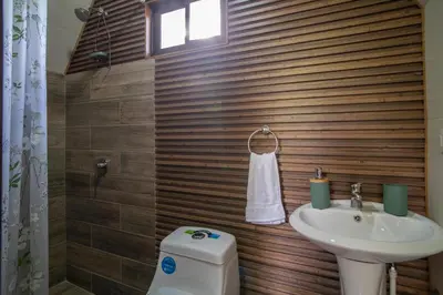 a bathroom with a sink and a toilet at Cabaña English Evergreen in Jardín