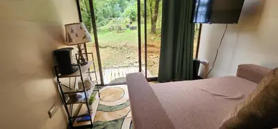 a room with a bed and a window with a view at Cabaña English Evergreen in Jardín