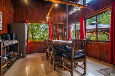 a dining room with a table and chairs at Cabaña English Evergreen in Jardín