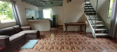 a living room with a couch and a staircase at Hospedaje Herradura de Rivas in Rivas
