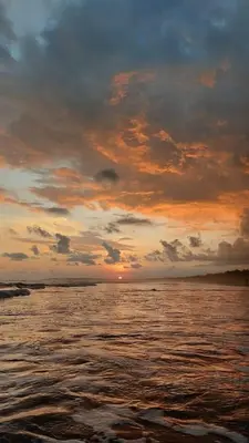 a sunset over a body of water with the ocean at An ideal place to share with family and friends in Bejuco