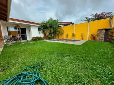 a yard with a hose laying in the grass at An ideal place to share with family and friends in Bejuco