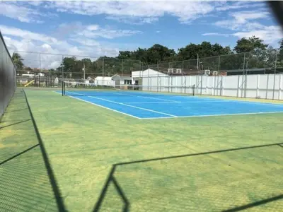 a tennis court with a net on top of it at An ideal place to share with family and friends in Bejuco