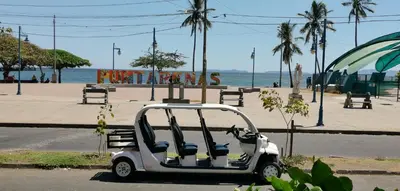 a golf cart parked on the side of a street at Hotel Aldea Pura Vida in Puntarenas