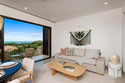 a living room with a couch and a table at Costa Elena at Naumi, Ocean Views & Beach Club in Sardinal