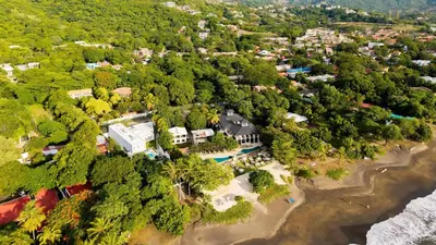an aerial view of a beach with trees and houses at Mar y Selva at Naumi, Ocean Views & Beach Club in Sardinal