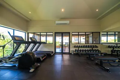 a gym with a lot of treadmills and machines at Mar y Selva at Naumi, Ocean Views & Beach Club in Sardinal
