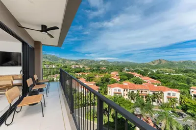 a balcony with a view of the mountains at Sol Pacífico at Naumi, Ocean Views & Beach Club in Sardinal