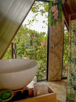 a bathroom with a sink and a large window at Tilawa La Fortuna Glamping in Ángeles