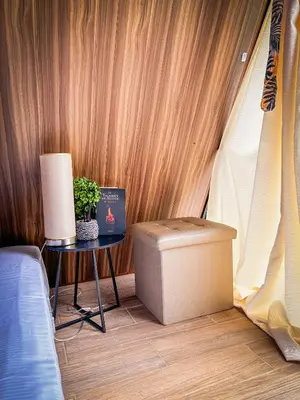 a corner of a room with a table and a bed at Tilawa La Fortuna Glamping in Ángeles