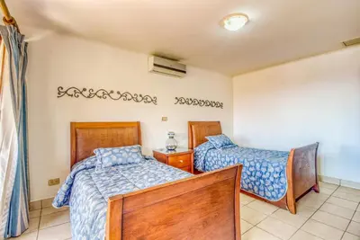 a bedroom with two beds and a window at Bahia Pez Vela Villa at 26 in Ocotal