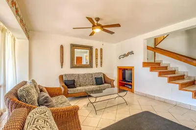 a living room with a couch and a ceiling fan at Bahia Pez Vela Villa at 26 in Ocotal