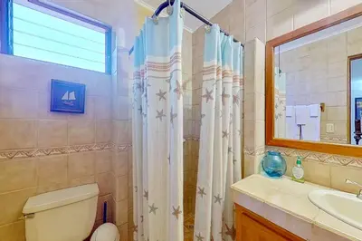 a bathroom with a shower and a toilet and a sink at Bahia Pez Vela Villa at 26 in Ocotal