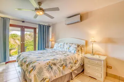 a bedroom with a bed and a window at Bahia Pez Vela Villa at 18 in Ocotal