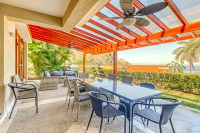 a patio with a table and chairs and a ceiling fan at Bahia Pez Vela Villa at 18 in Ocotal