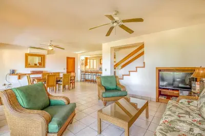 a living room with a couch and chairs and a television at Bahia Pez Vela Villa at 18 in Ocotal