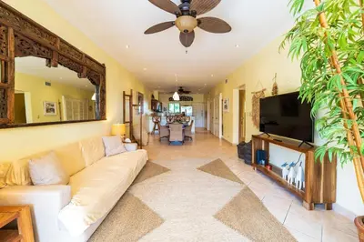 a living room with a white couch and a flat screen tv at Sunrise 7 - 2 Bedroom, Ocean View Condo in Tamarindo