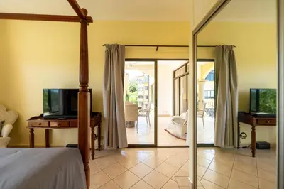 a bedroom with a bed and a sliding glass door at Sunrise 7 - 2 Bedroom, Ocean View Condo in Tamarindo