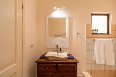 a bathroom with a sink and a mirror at Sunrise 7 - 2 Bedroom, Ocean View Condo in Tamarindo