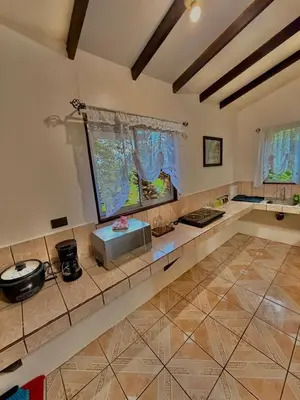 a large kitchen with a counter top in a room at Loma Real Hot Springs Bed & Breakfast in Fortuna