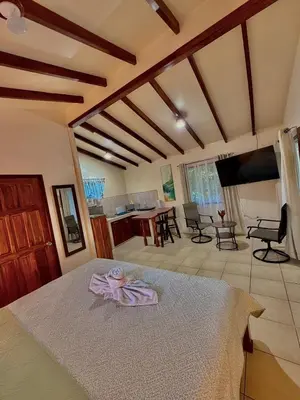 a bedroom with a bed with a towel on it at Loma Real Hot Springs Bed & Breakfast in Fortuna