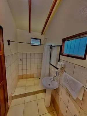 a bathroom with a sink and a shower at Loma Real Hot Springs Bed & Breakfast in Fortuna