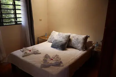 a bedroom with a bed with towels on it at Cabinas Las Chinitas in Zapotal