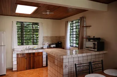 a kitchen with a sink and a counter top at Cabinas Las Chinitas in Zapotal