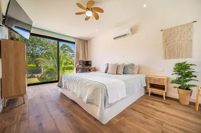 a bedroom with a bed and a large window at Casa Nonos in Libertad