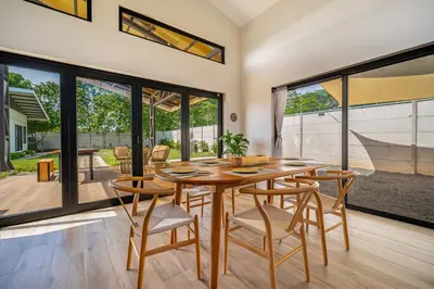 a dining room with a wooden table and chairs at Casa Nonos in Libertad