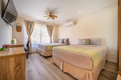 a hotel room with two beds and a tv at Casa Nonos in Libertad