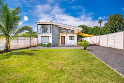 a house with a fence and a yard at Casa Nonos in Libertad