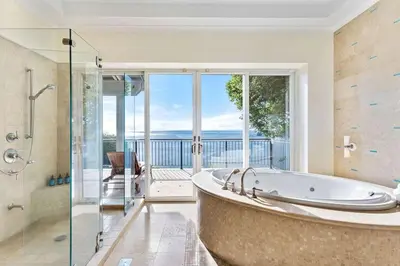 a large bathroom with a tub and a glass shower at Papagayo Villa w Ocean Views and 2 Private Pools in Nacascolo