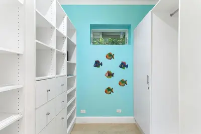 a hallway with white closets and a blue wall with butterflies at Papagayo Villa w Ocean Views and 2 Private Pools in Nacascolo