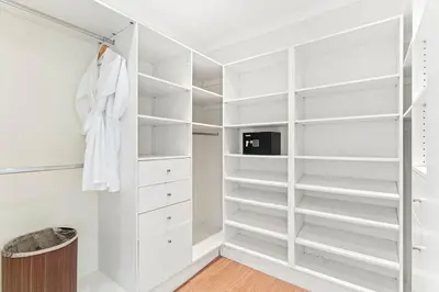 a white walk in closet with white shelves at Papagayo Villa w Ocean Views and 2 Private Pools in Nacascolo