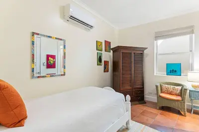 a bedroom with a bed and a chair and a window at Papagayo Villa w Ocean Views and 2 Private Pools in Nacascolo
